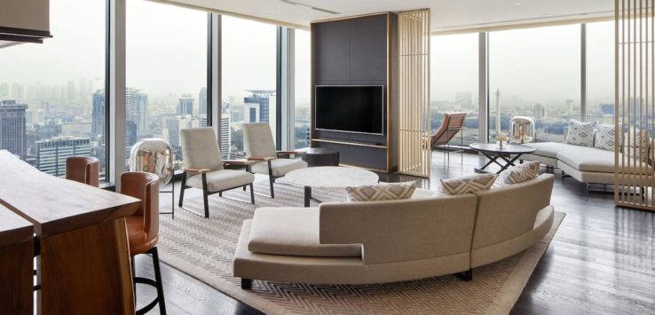 a living room with a large window overlooking a city