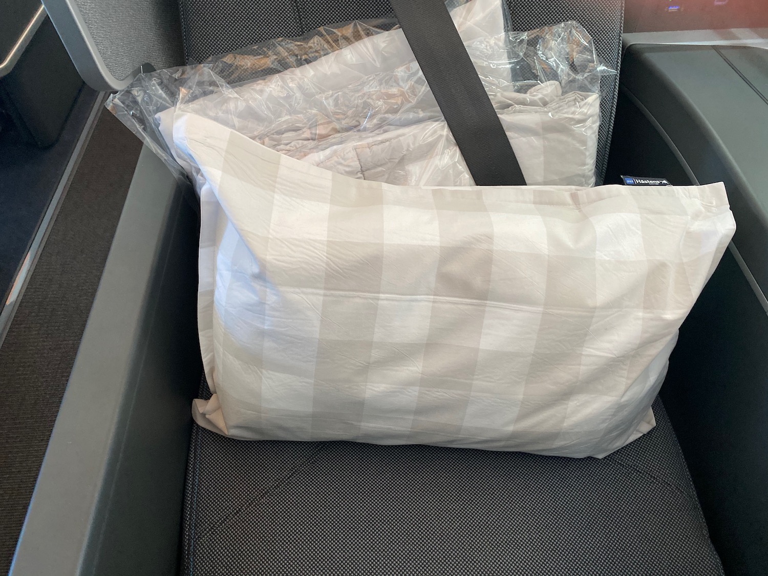 a pillow and a bag on a seat