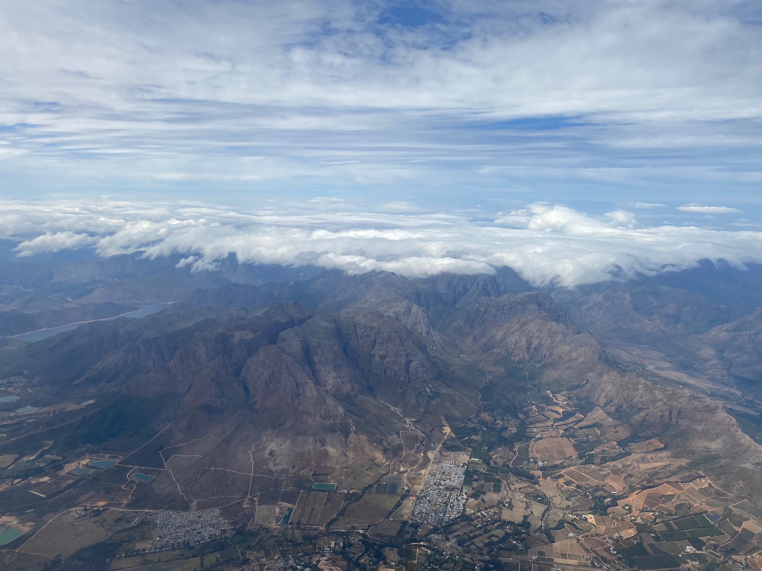 aerial view of a valley with clouds and mountains