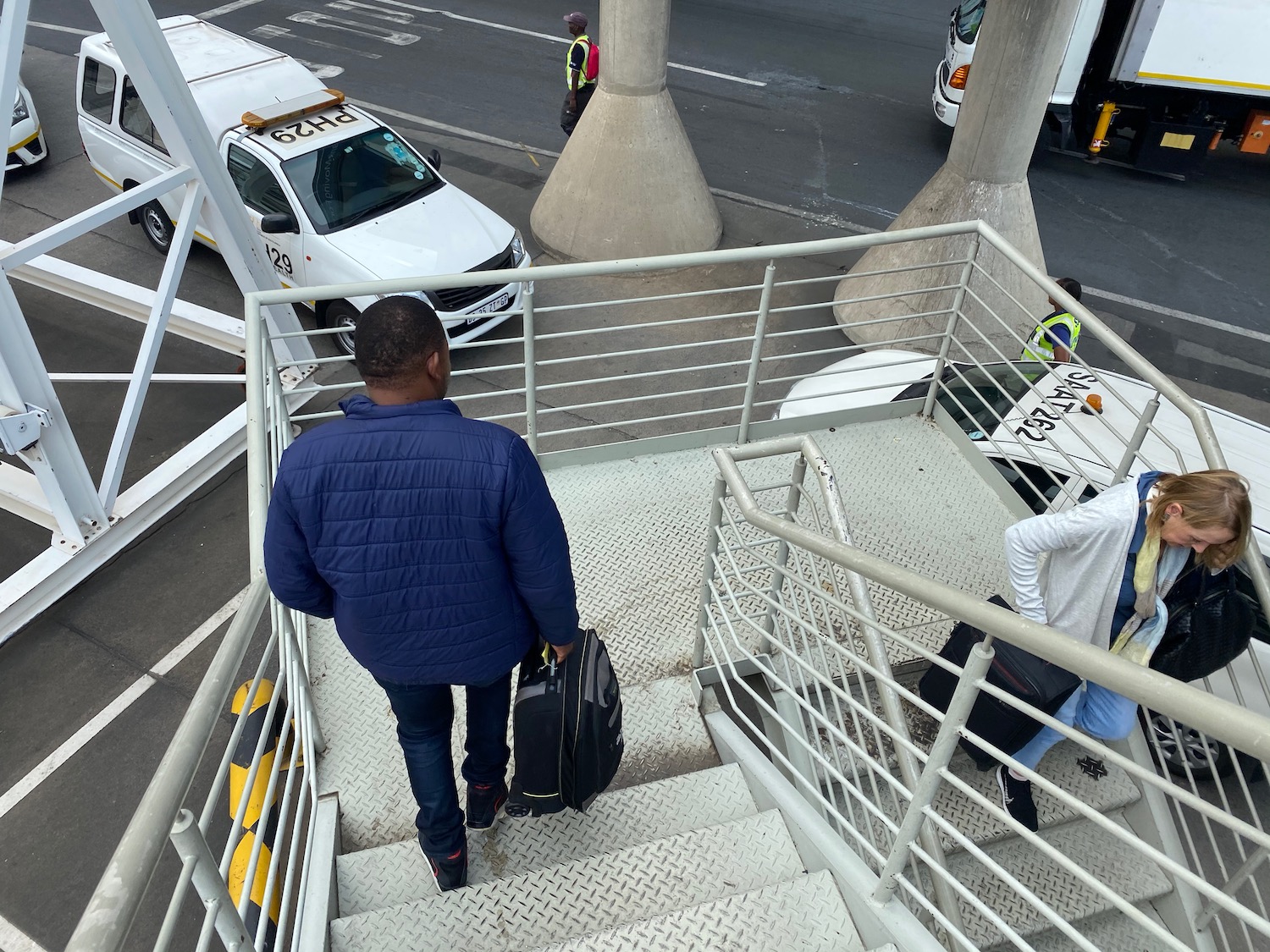 a man walking up stairs with luggage