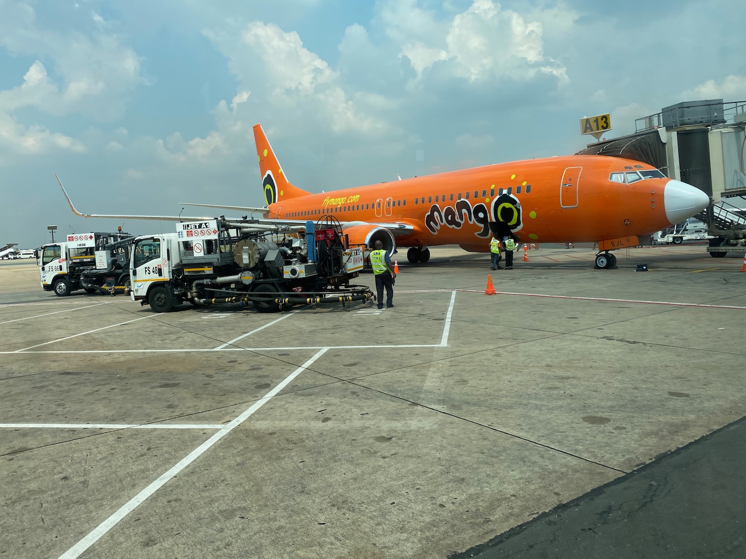 an orange airplane on a tarmac