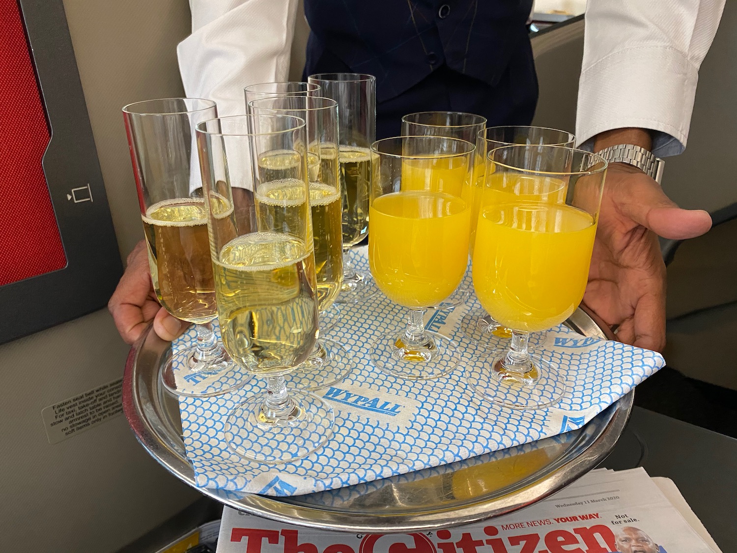 a tray of glasses filled with yellow liquid