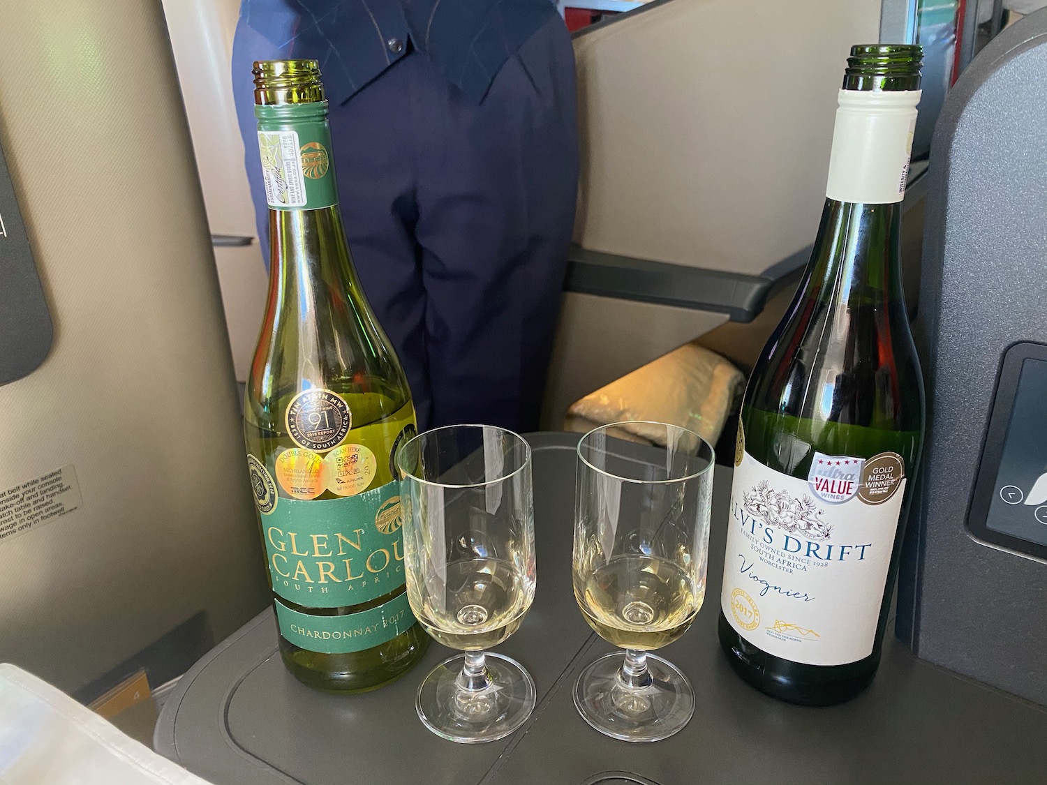 a group of wine bottles and glasses on a table