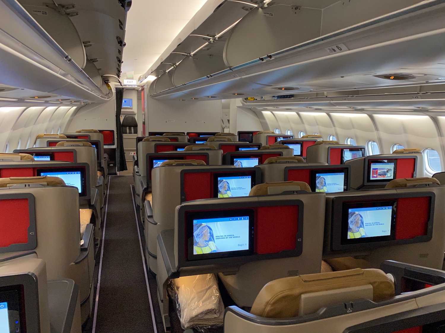 a row of seats with monitors on the side