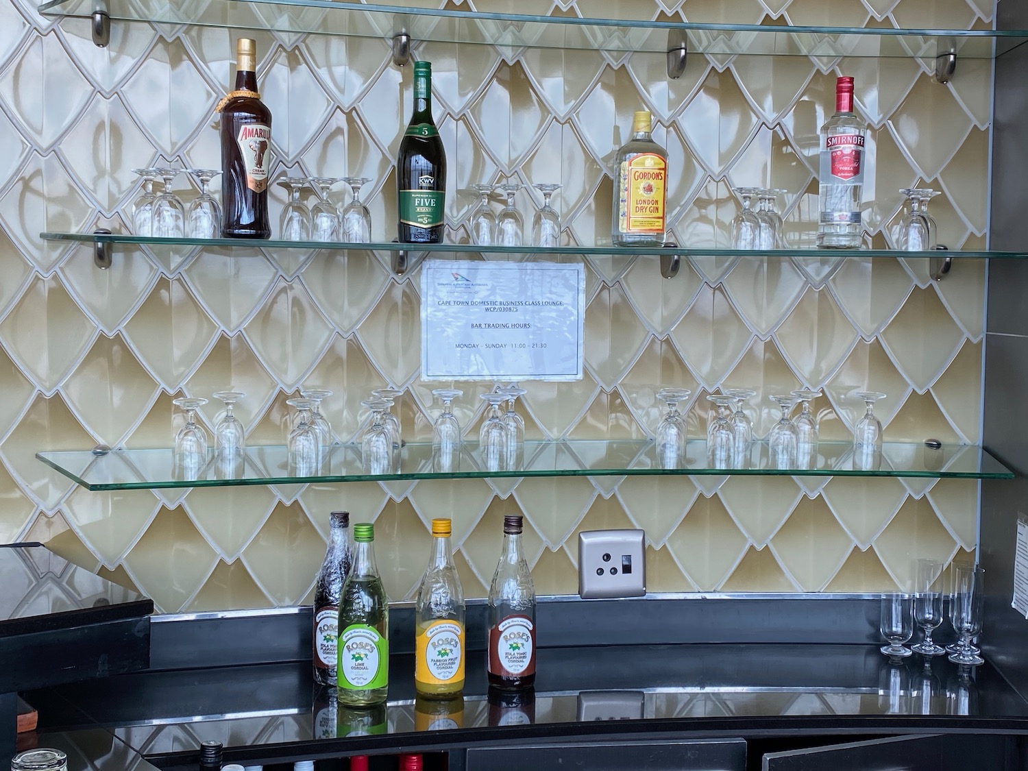 a shelf with bottles and glasses on it