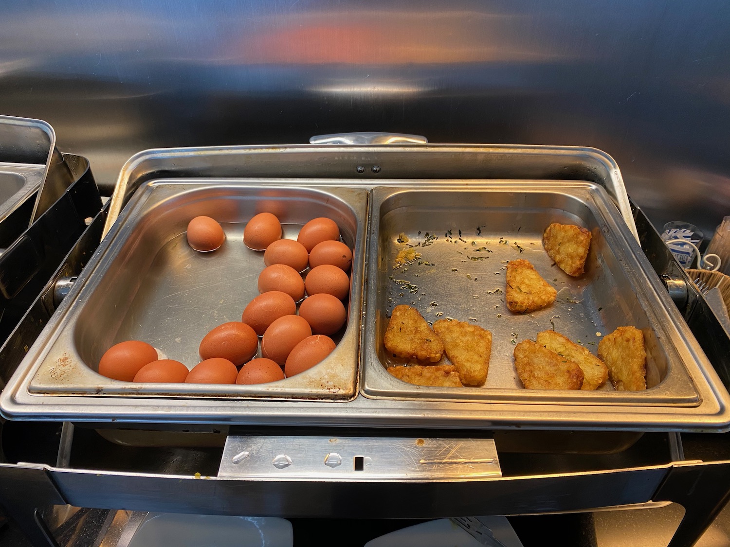 a tray of food with eggs and hash browns