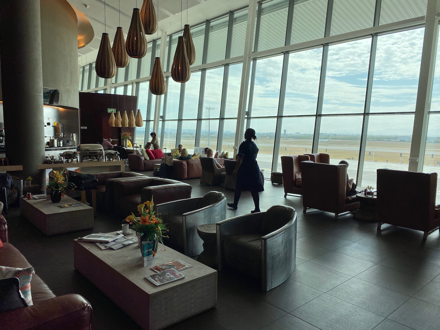 a room with large windows and chairs and tables