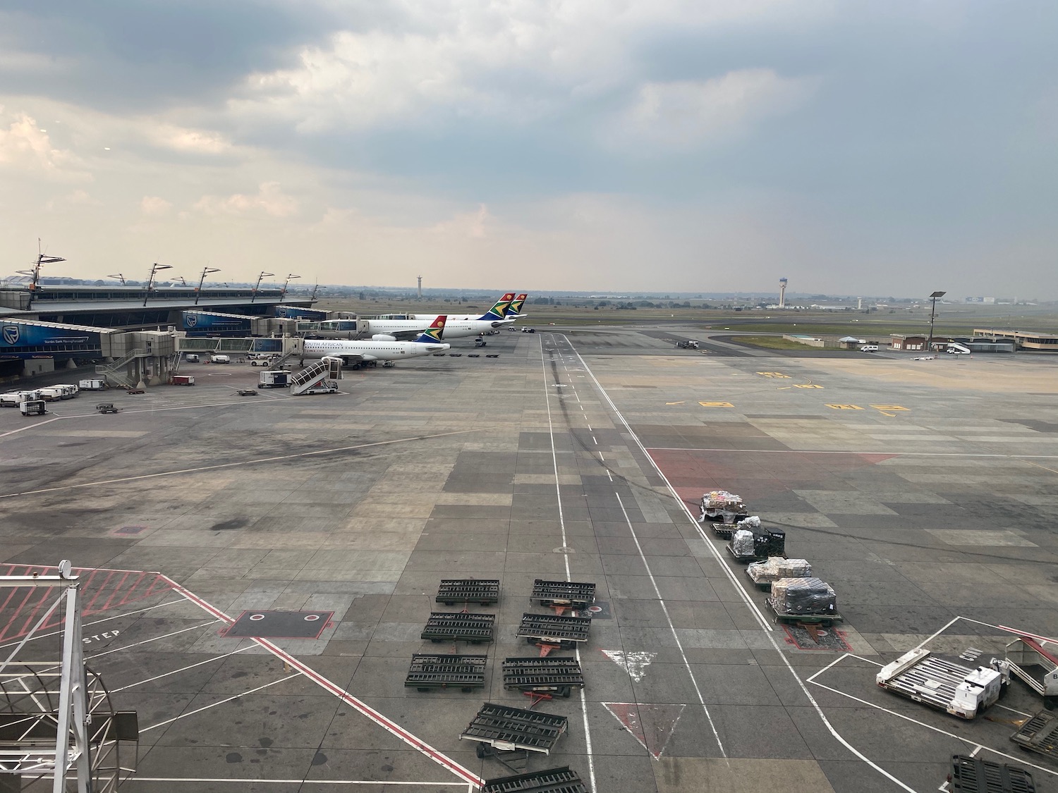 an airport with a plane and luggage