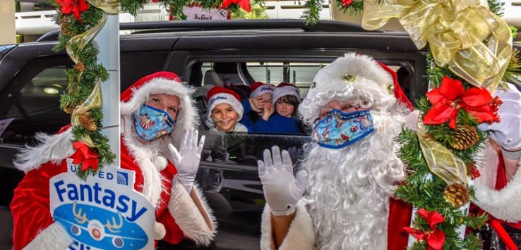 a group of people in santa clothing and masks