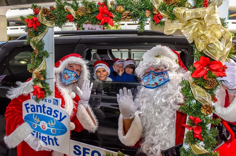 a group of people in santa clothing and masks