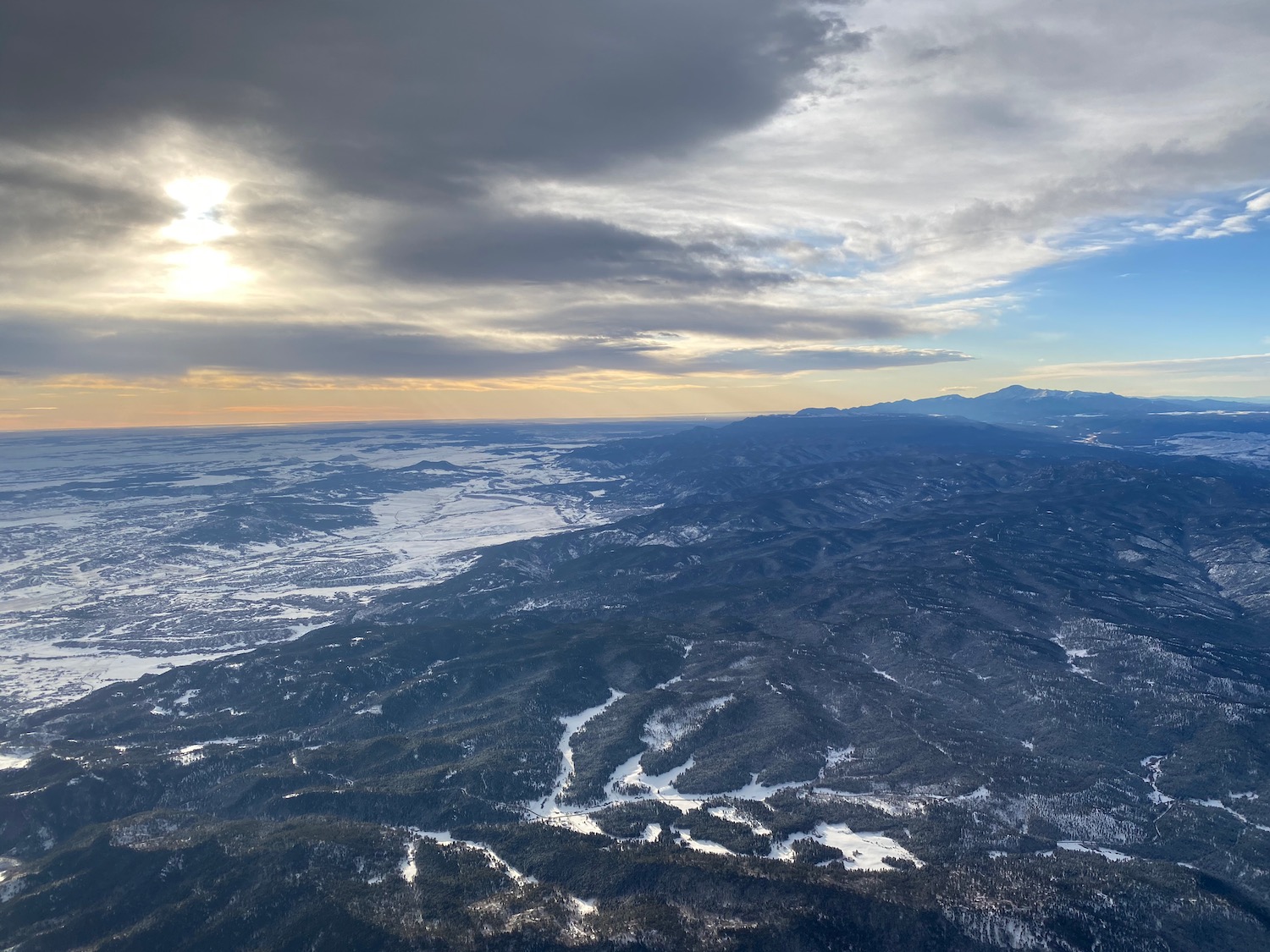 a landscape with snow and clouds