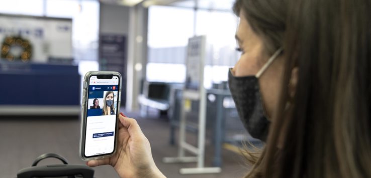 a woman wearing a mask and holding a phone