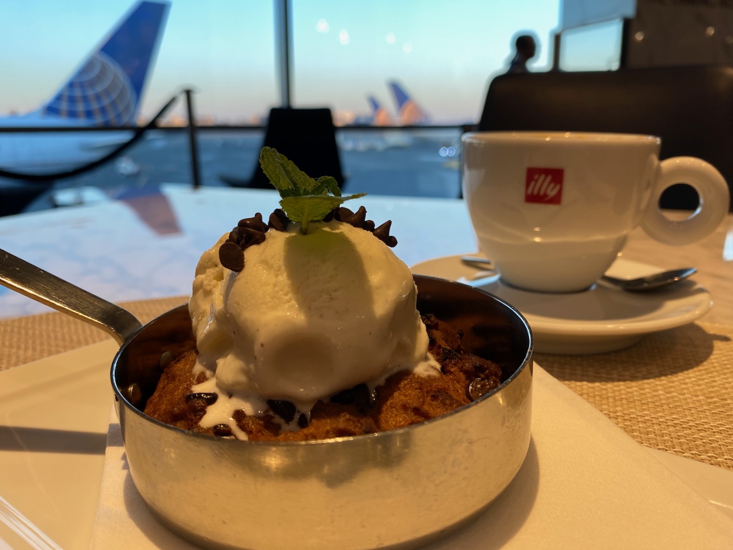 a dessert in a pot with ice cream and mint leaves