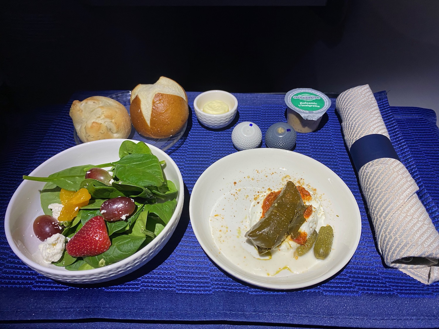 a plate of food and a napkin on a blue surface