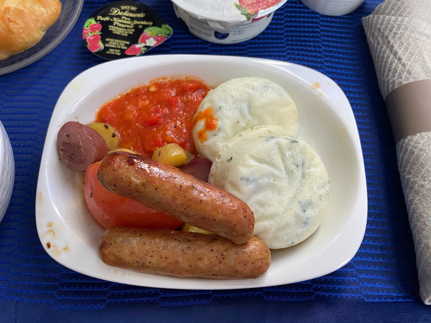 a plate of sausages and potatoes