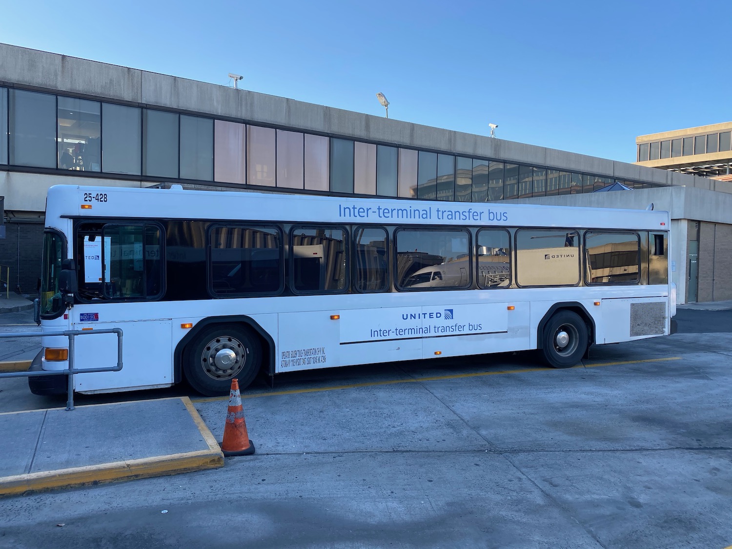 a white bus parked in front of a building