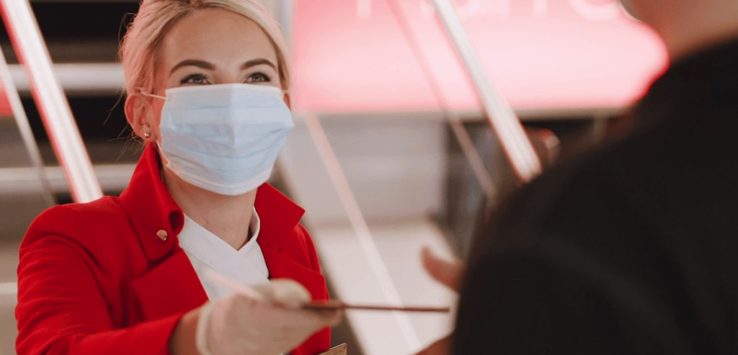 a woman wearing a mask and gloves