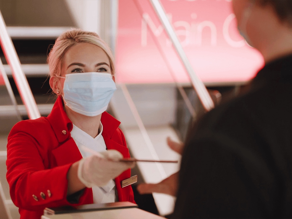 a woman wearing a mask and gloves