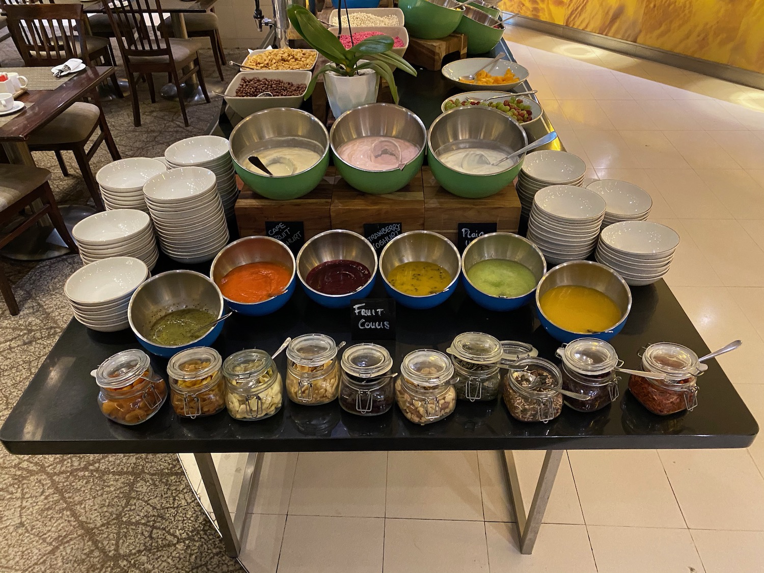 a table with bowls of food and plates