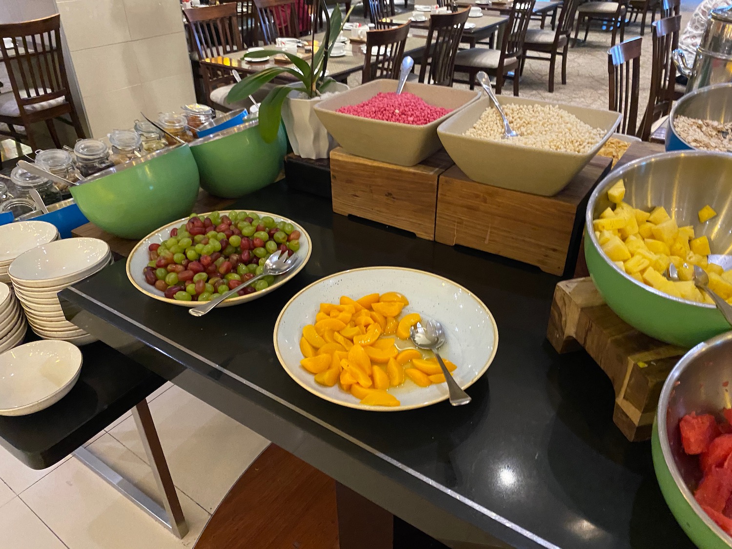 a table with bowls of fruit and bowls of food