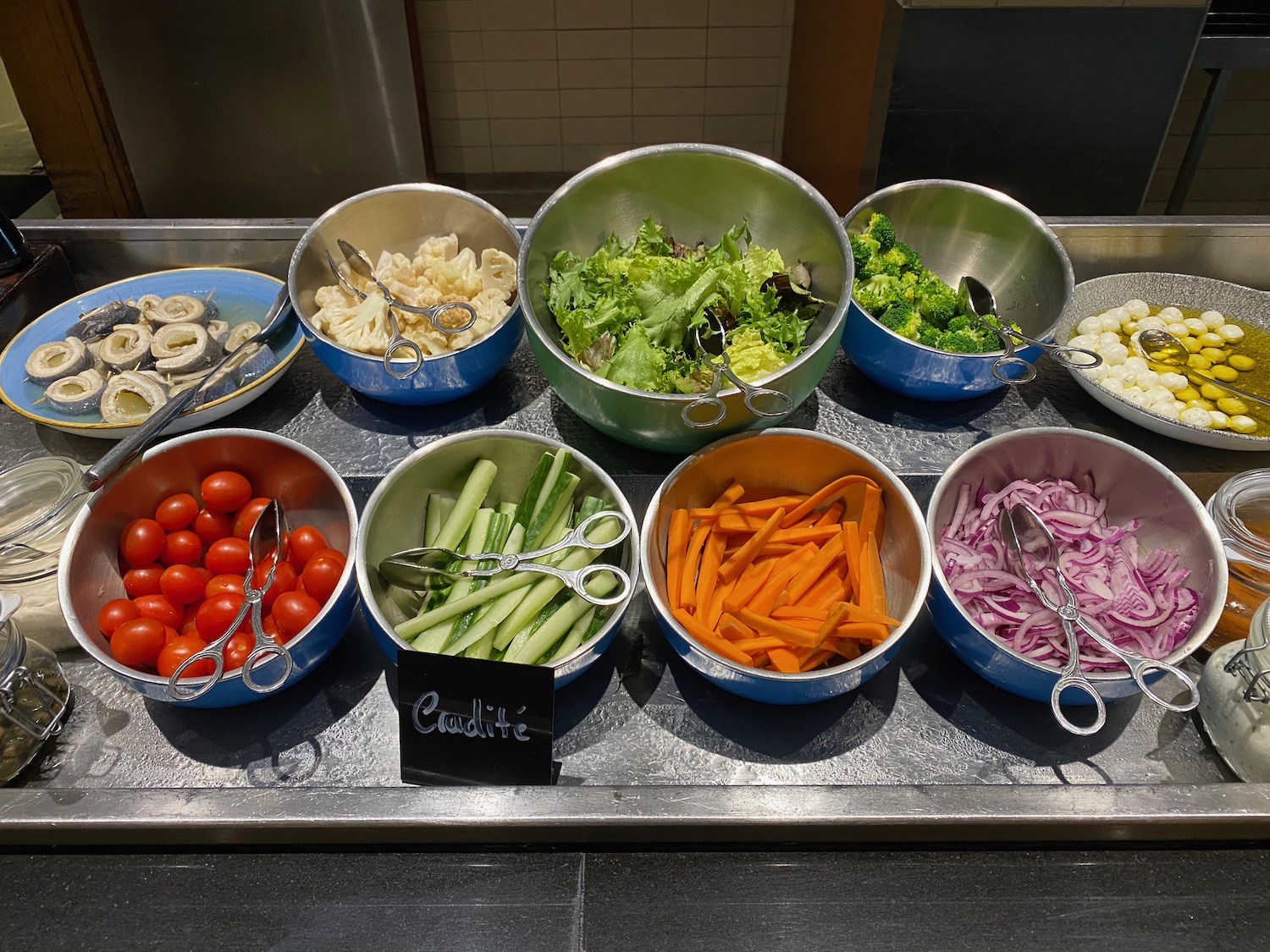 a group of bowls of vegetables and a fork