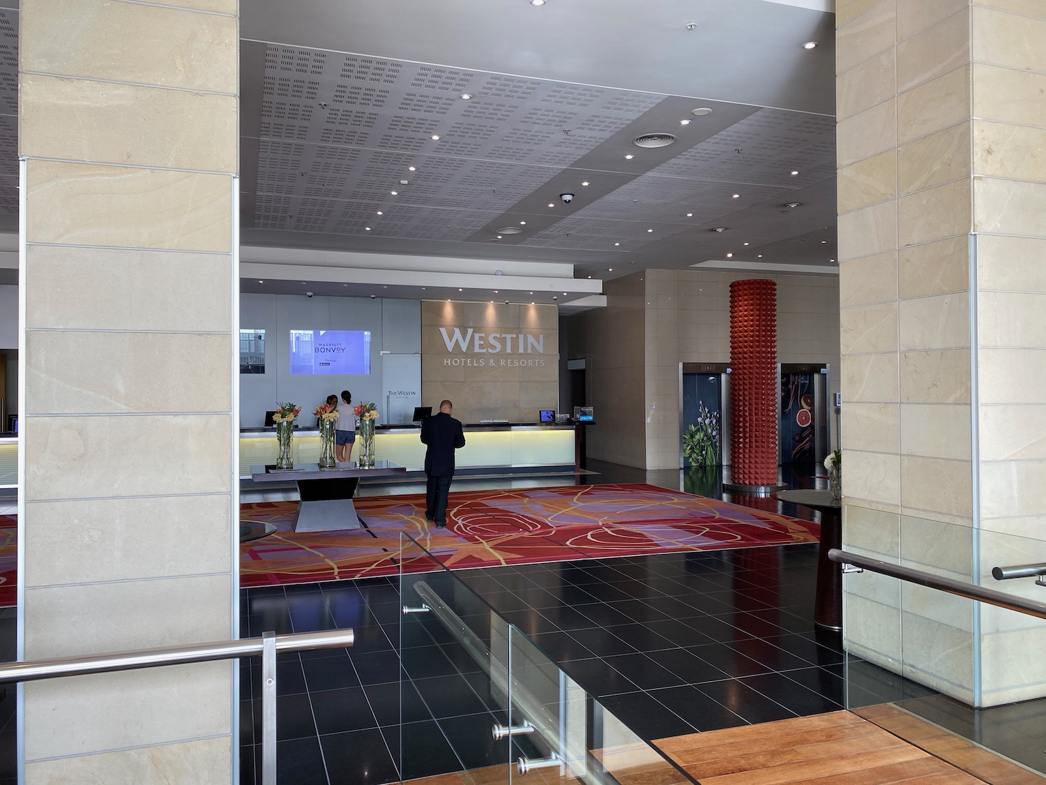 a man standing in front of a reception desk