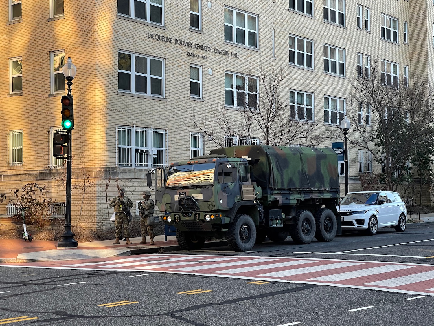 a military truck parked on the side of a street