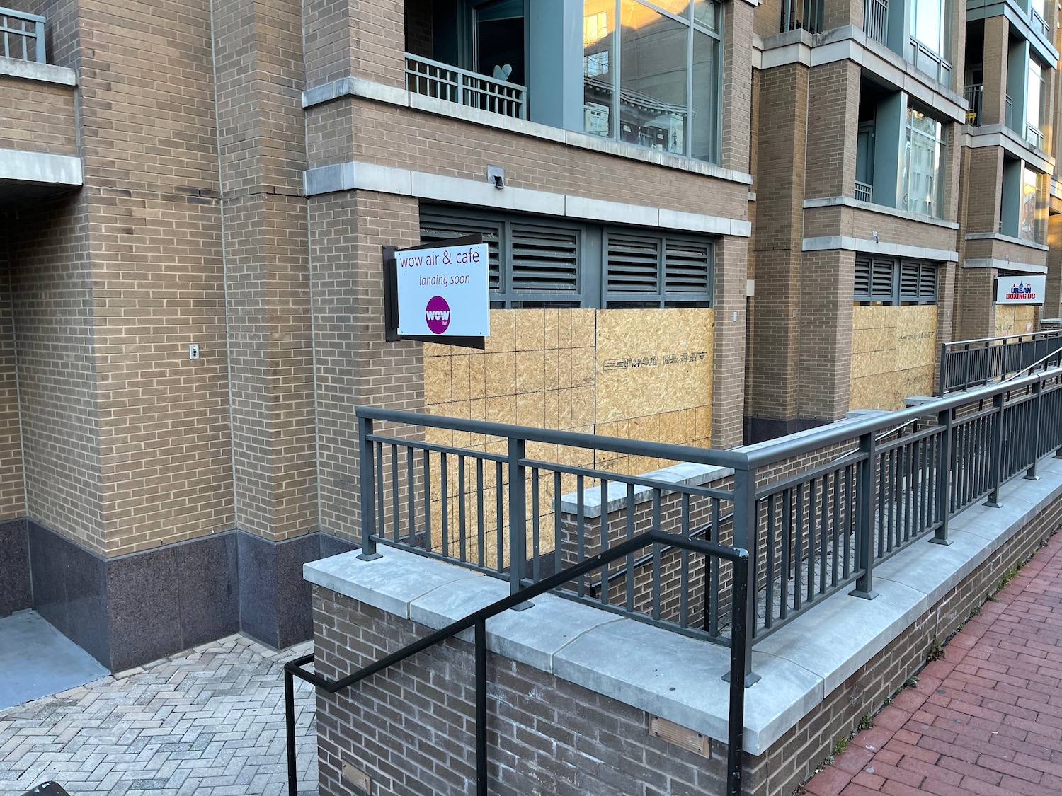 a building with a railing and a sign