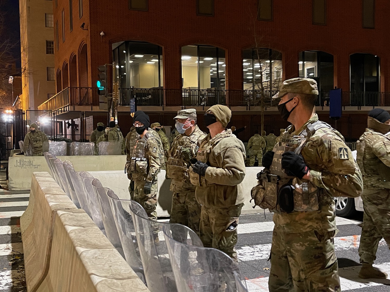 a group of people in military uniforms standing in front of a building