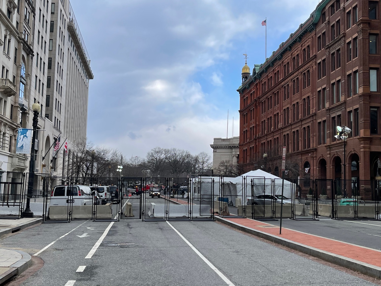 a street with a fence and a building