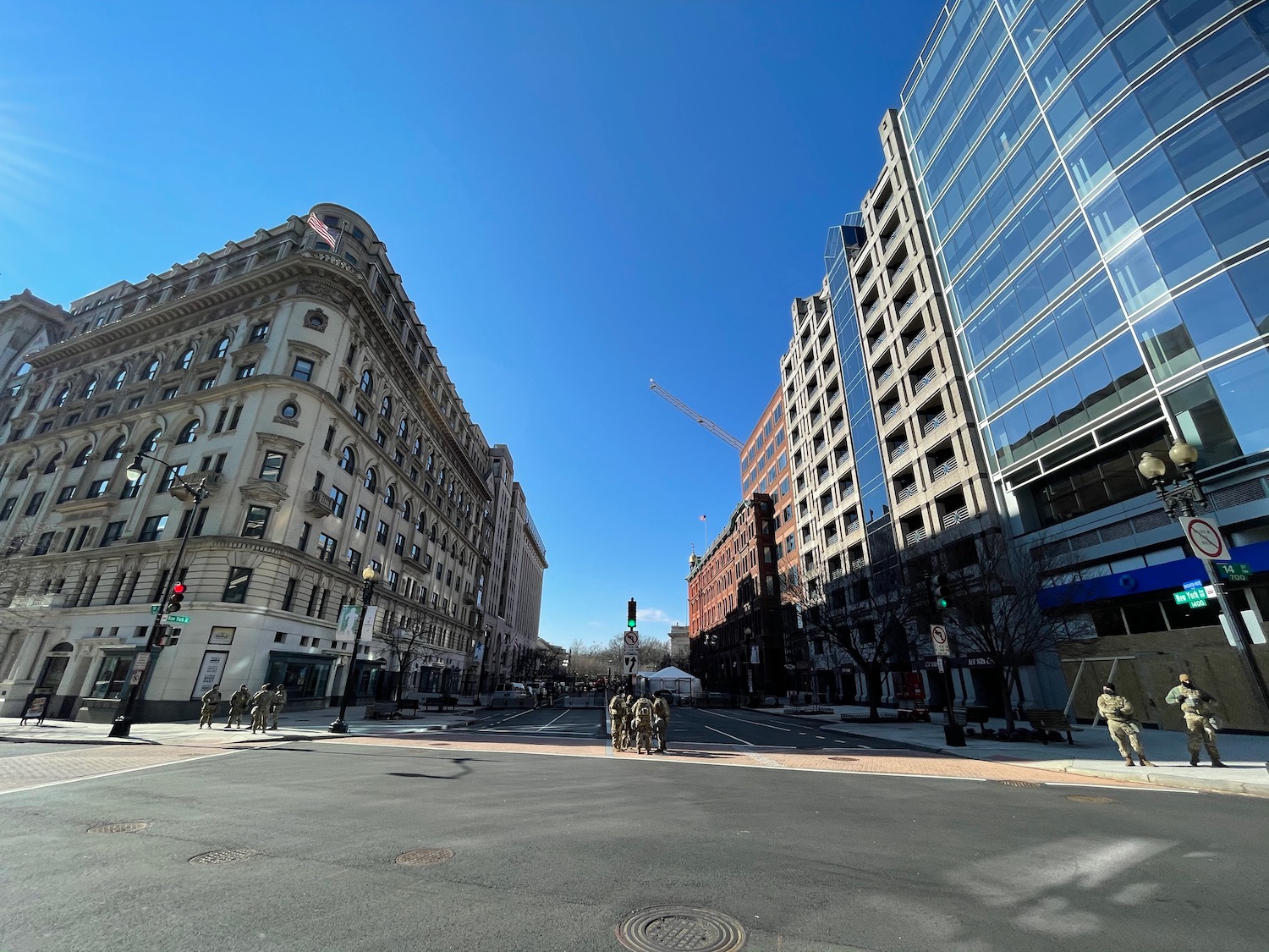 a group of people standing in a street with buildings in the background