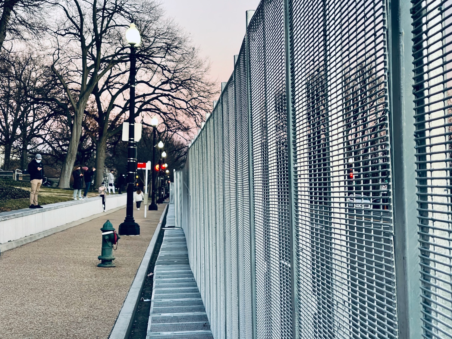 a fence on a sidewalk