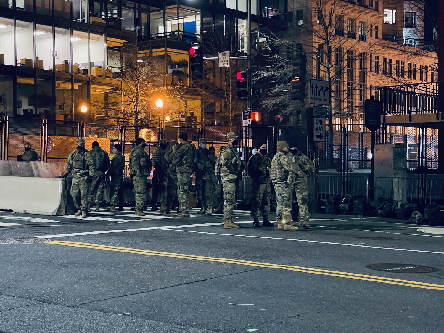 a group of people in military uniforms standing in a line on a street