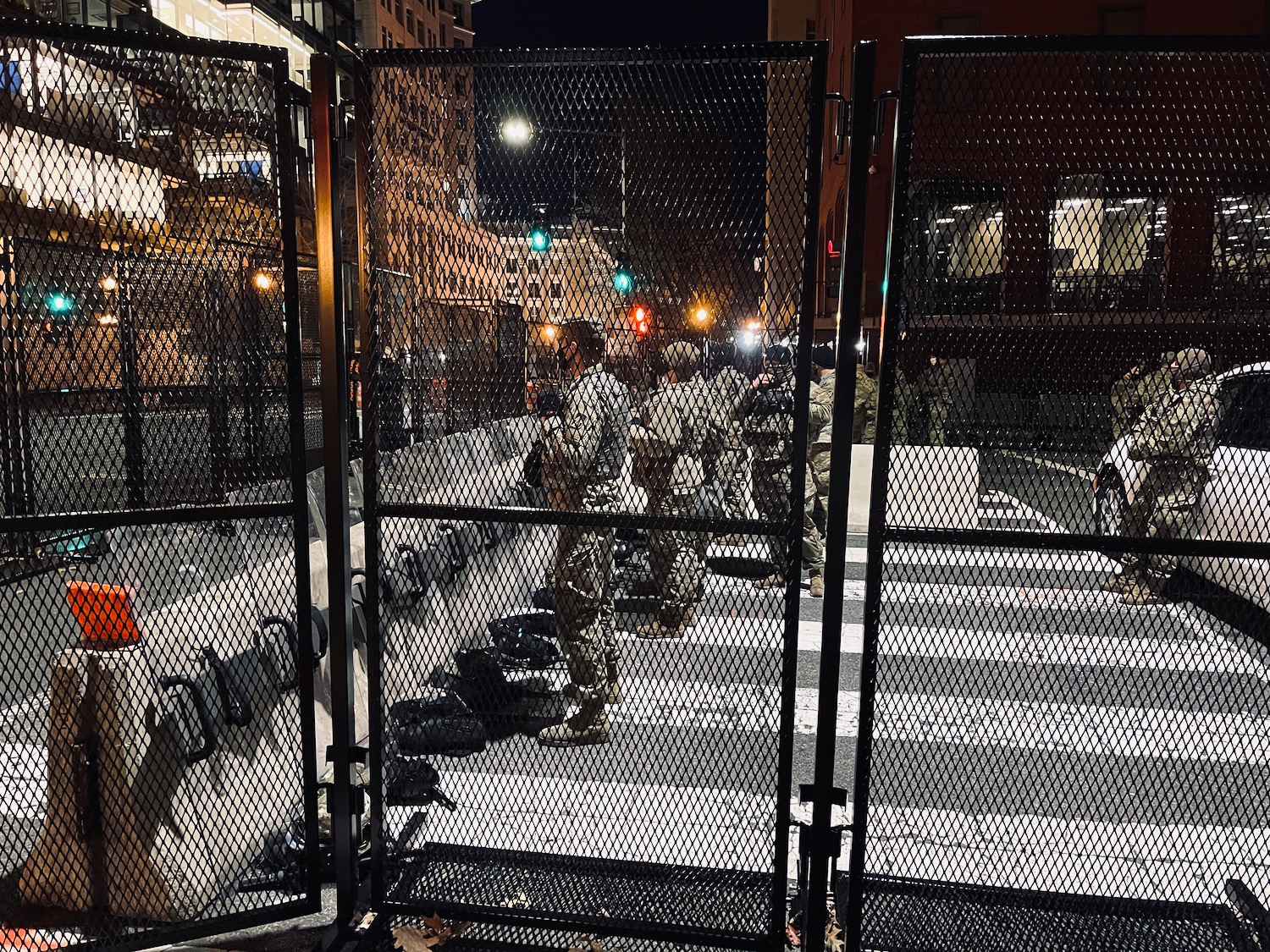 a group of people standing in front of a fence