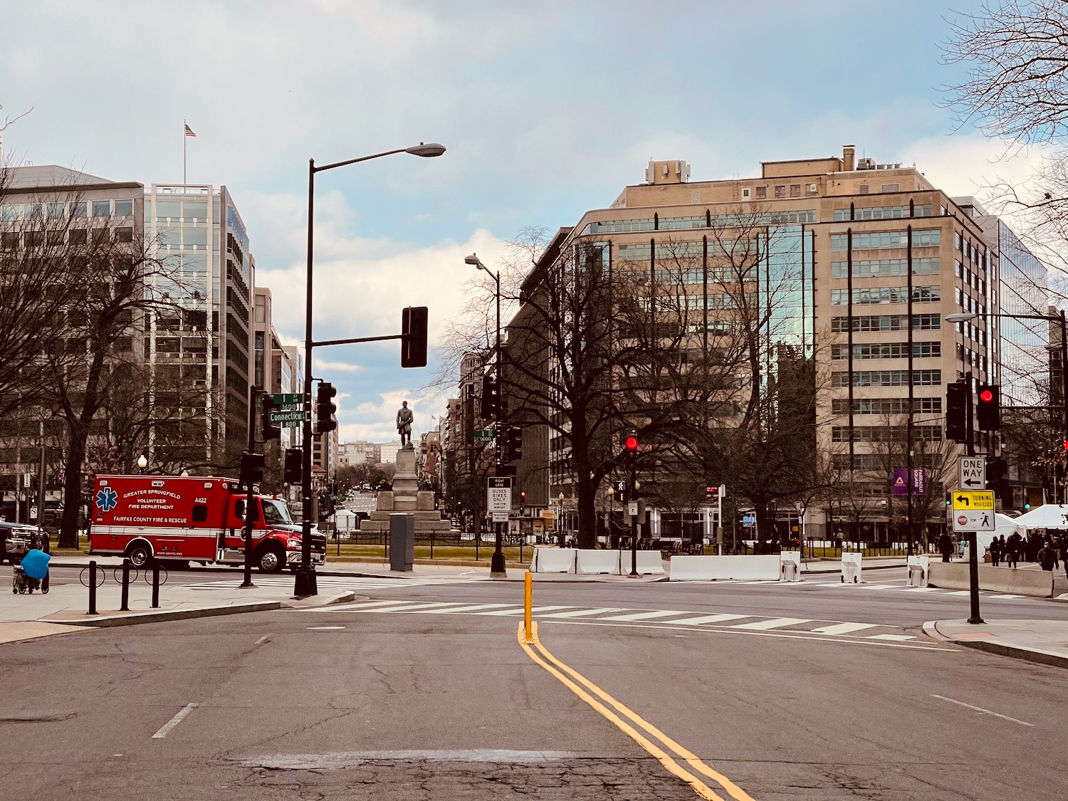 a street with a red truck and buildings