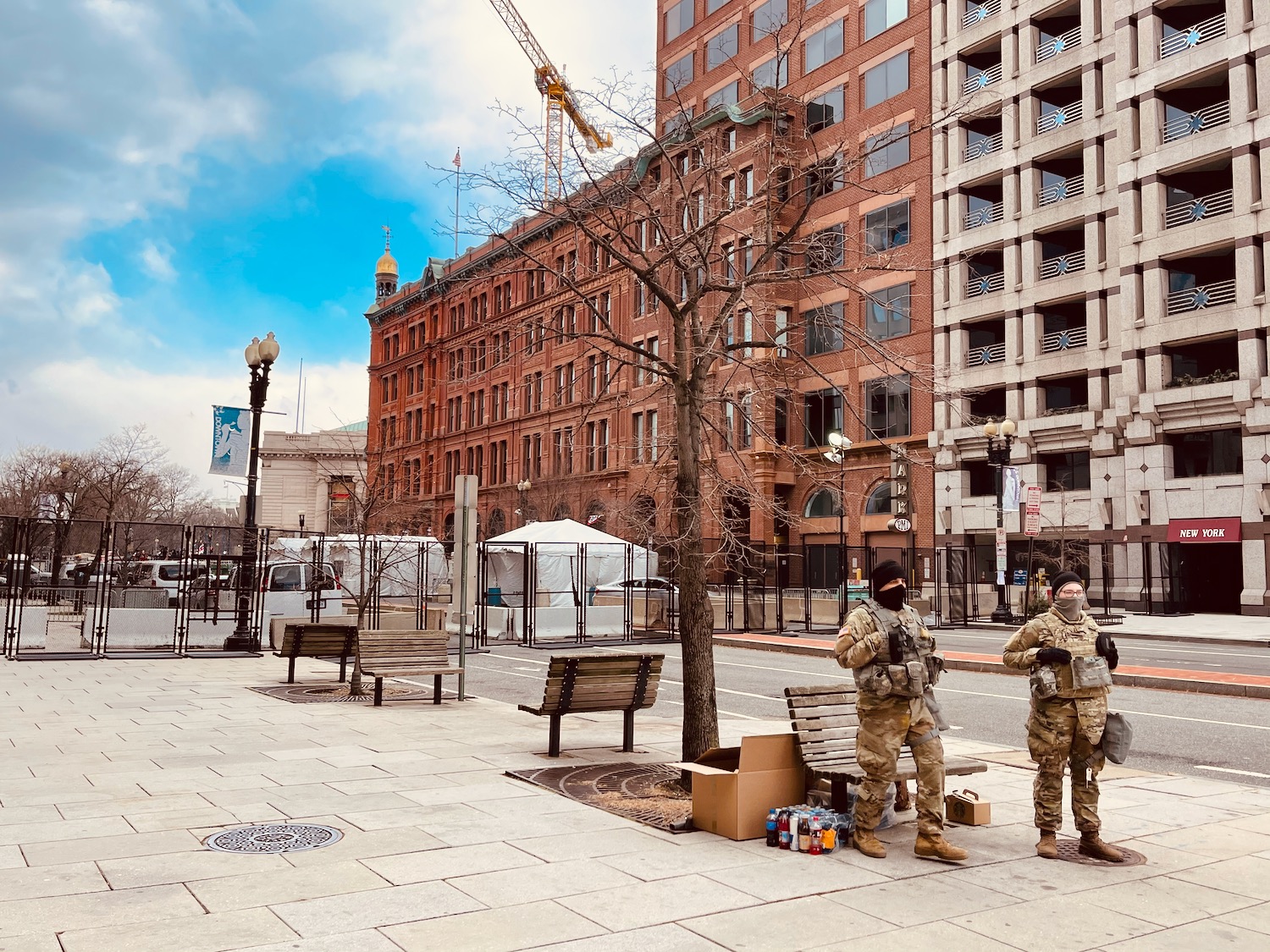 a group of people in military uniforms on a sidewalk