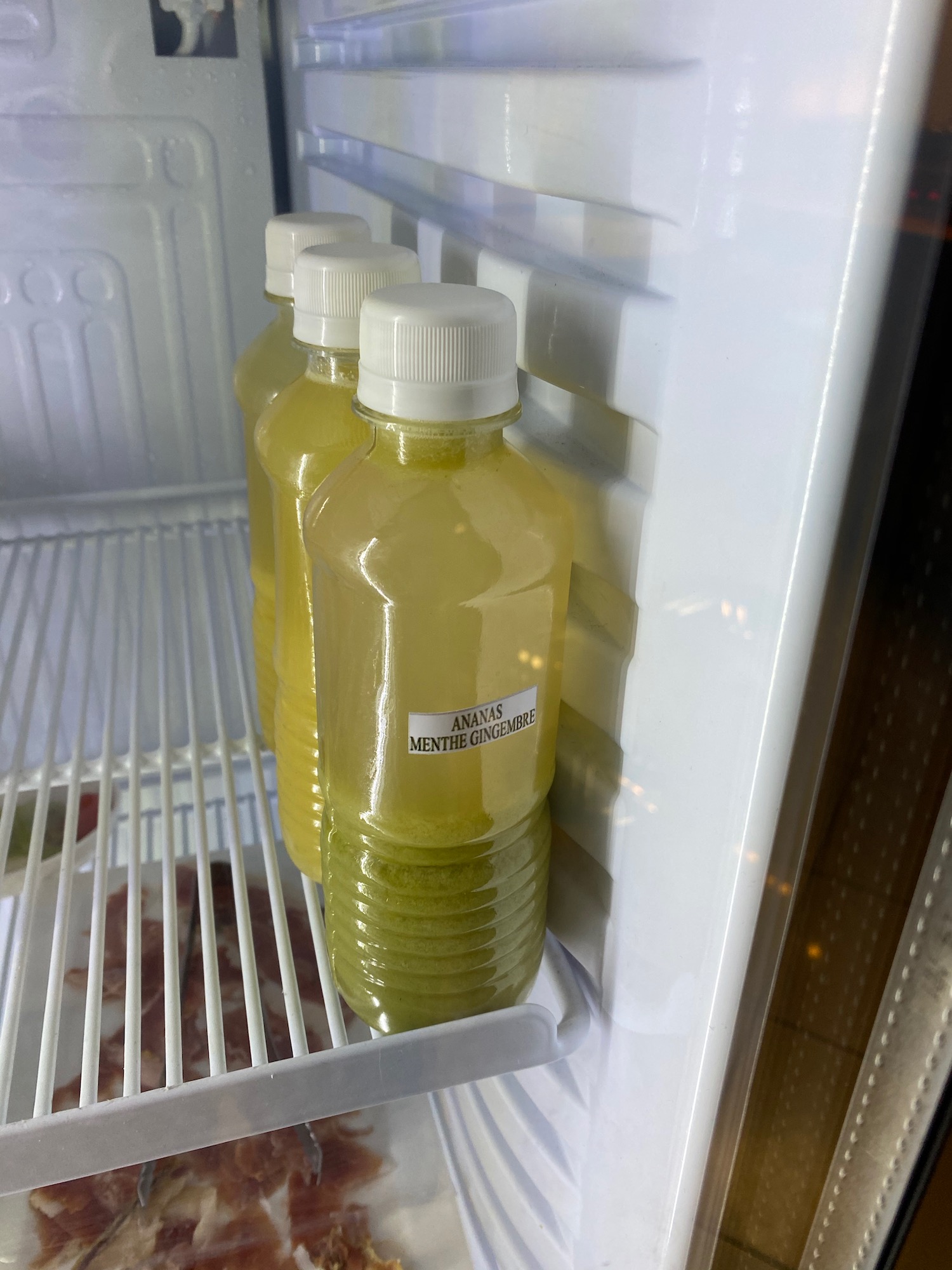 bottles of juice in a refrigerator