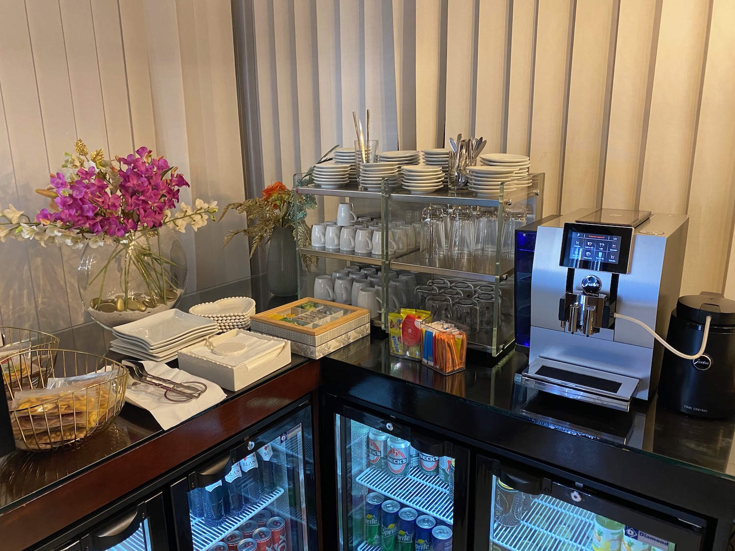 a coffee machine and drinks on a counter