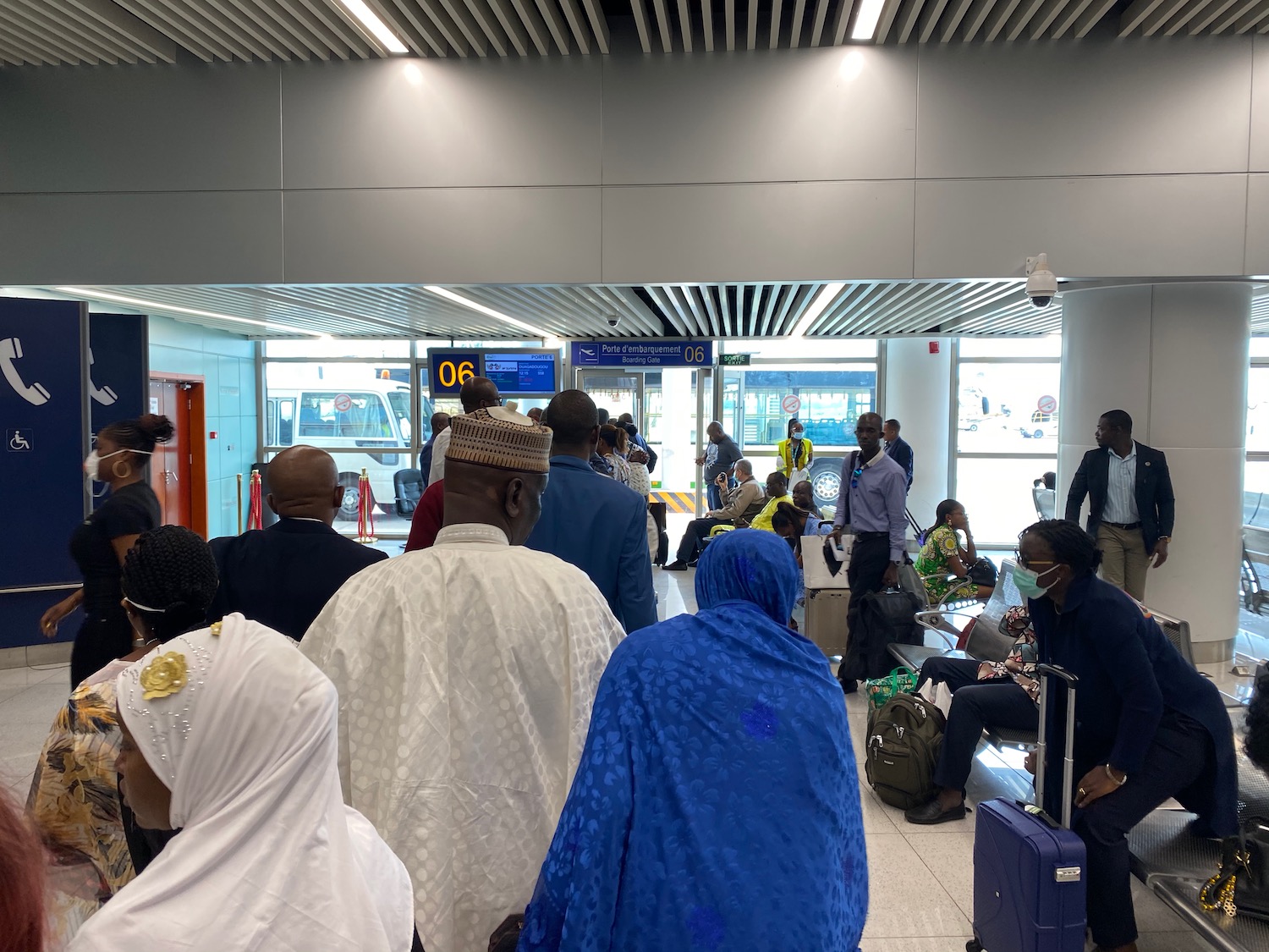 a group of people in a room with luggage