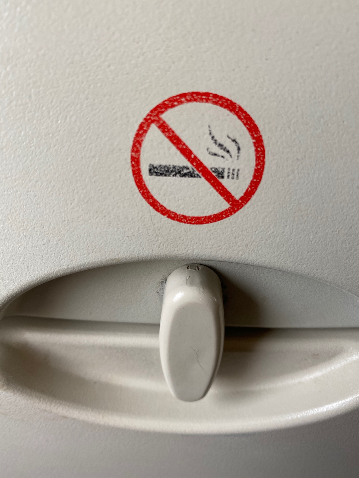 a no smoking sign on a plane