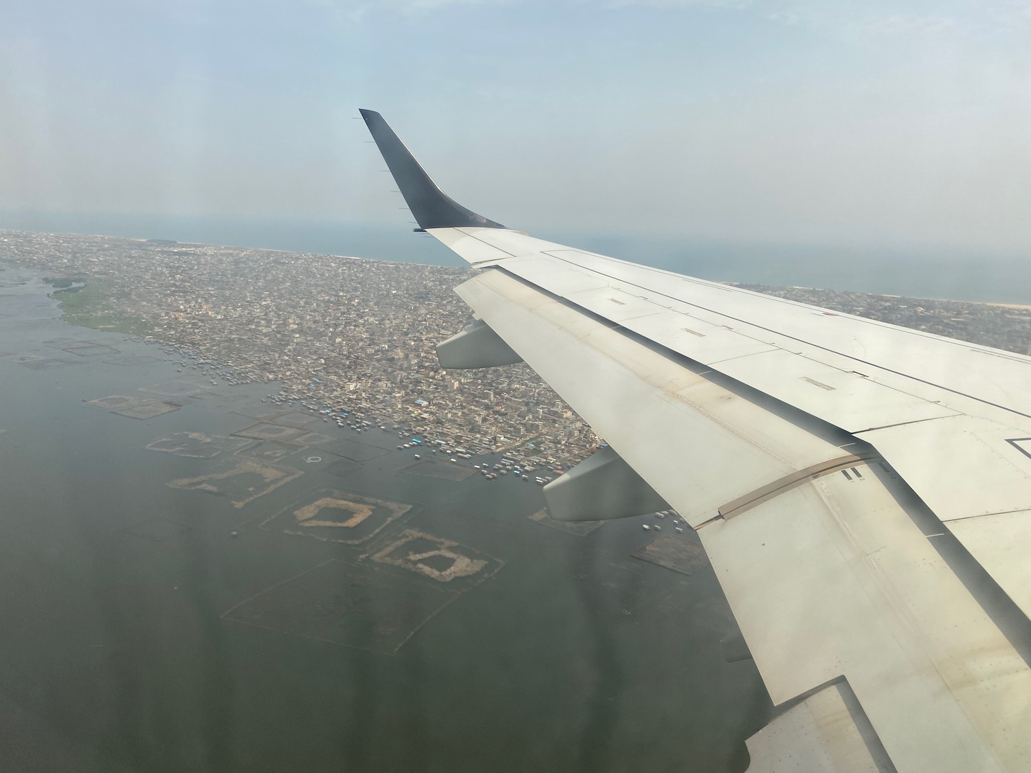 an airplane wing above a city