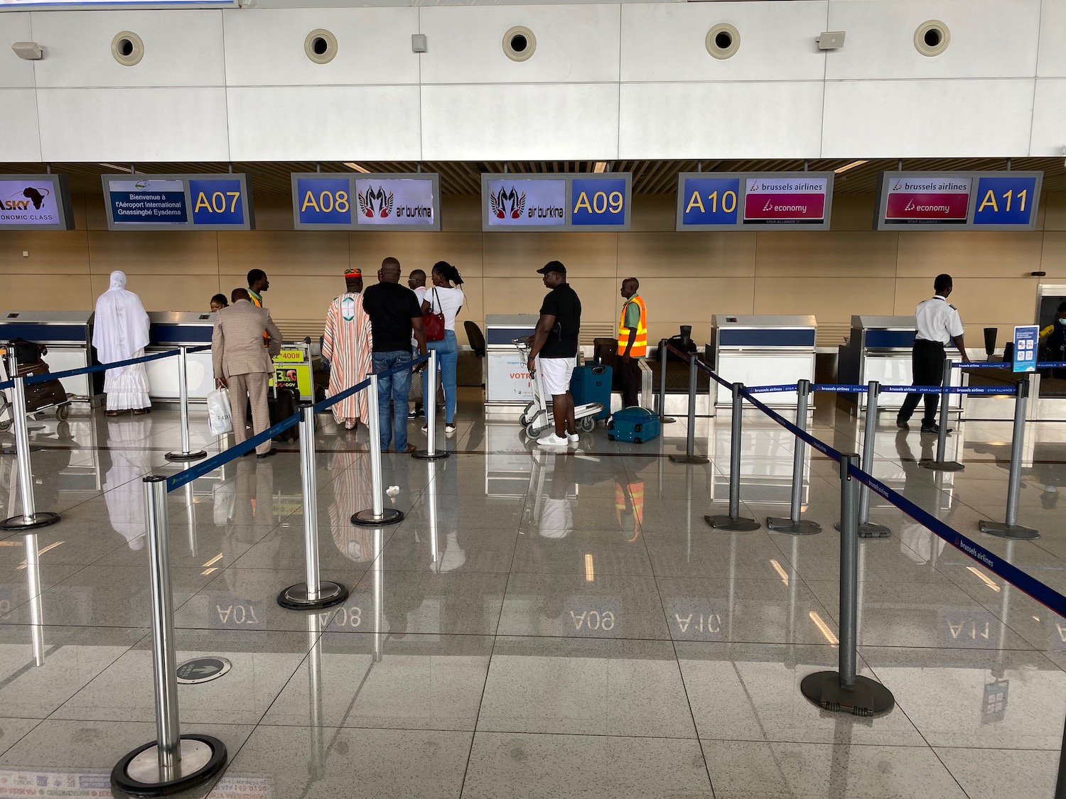 people standing in a line at an airport