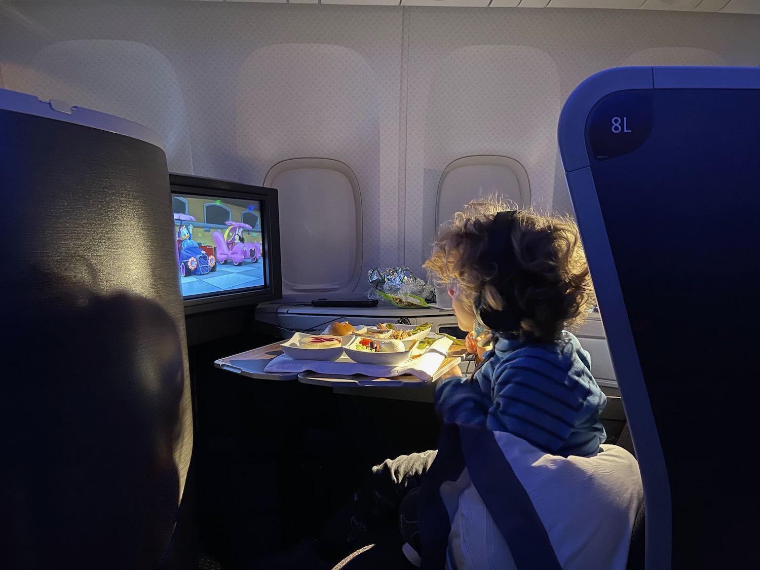 a child eating food in an airplane