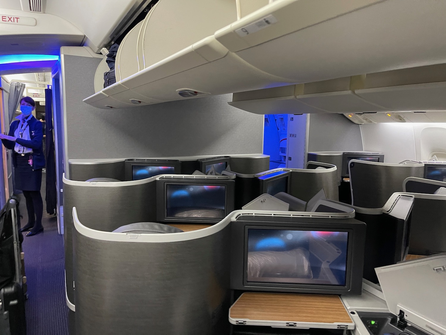 a group of tvs and tables in an airplane