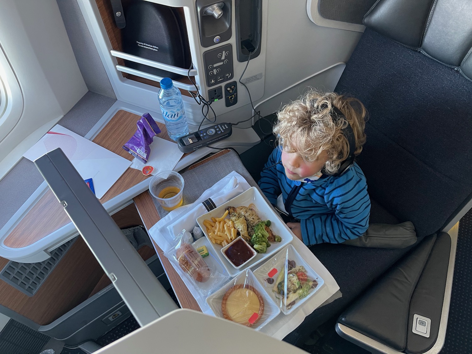 a child sitting in a chair with food on it