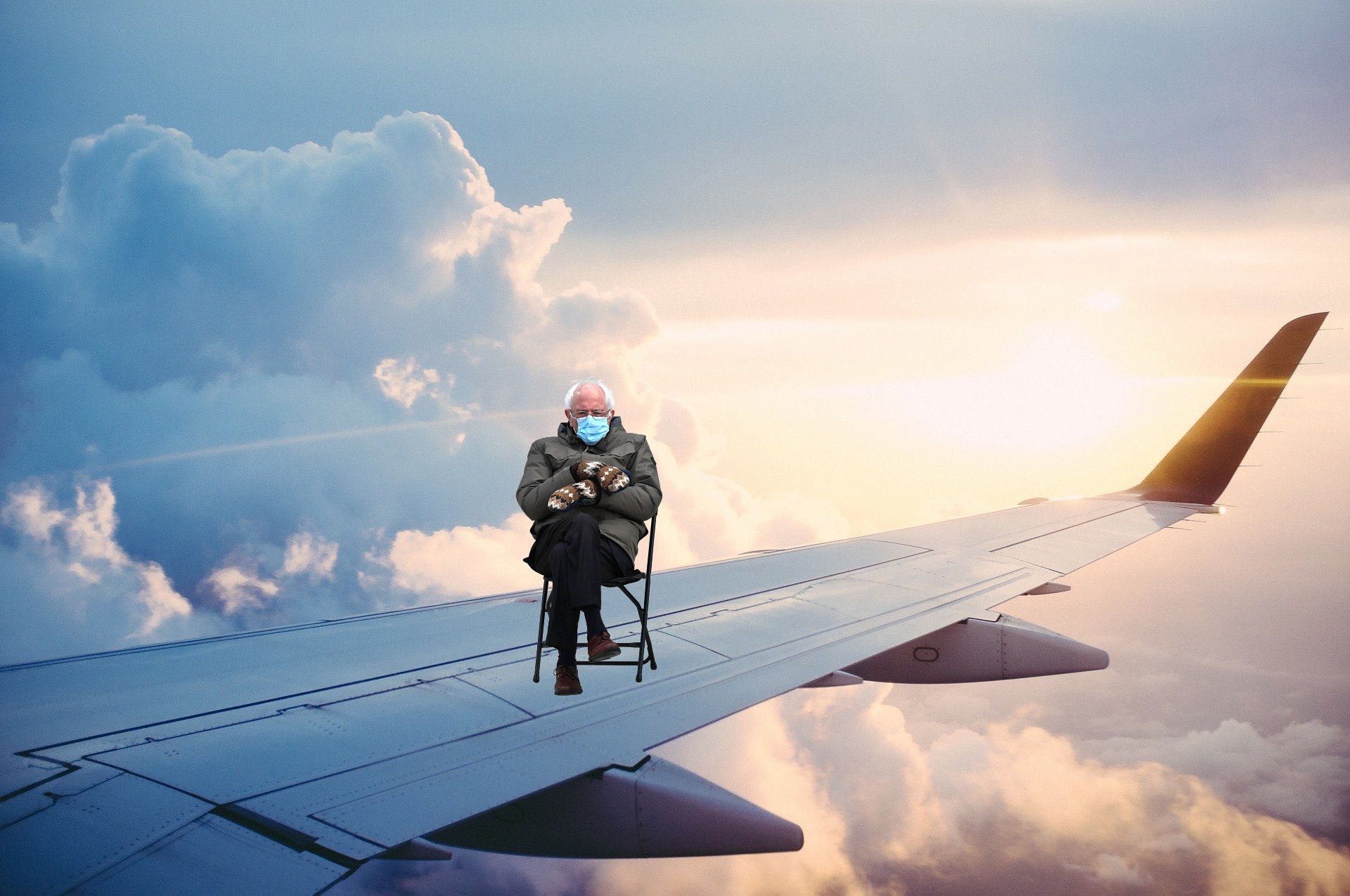 an old man sitting in a chair on an airplane wing