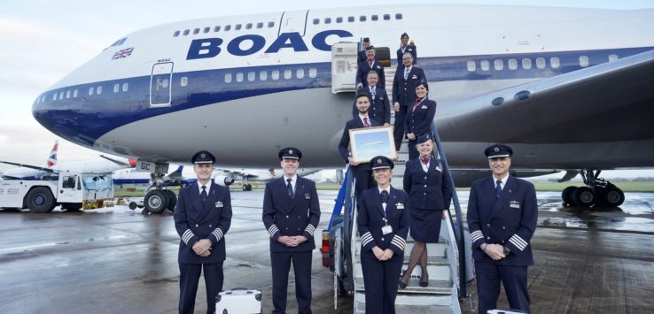 a group of people in uniform standing on stairs of an airplane