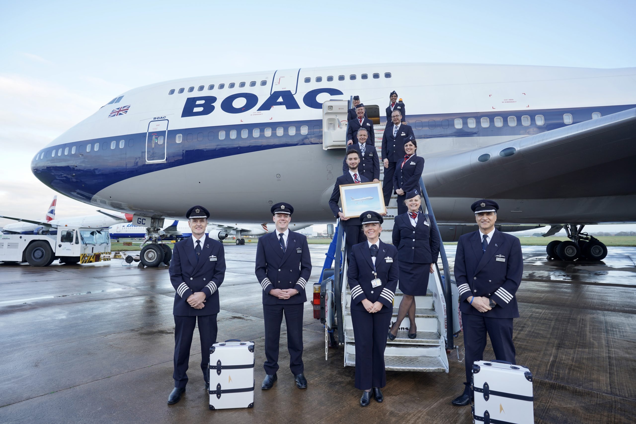 a group of people in uniform standing on stairs of an airplane