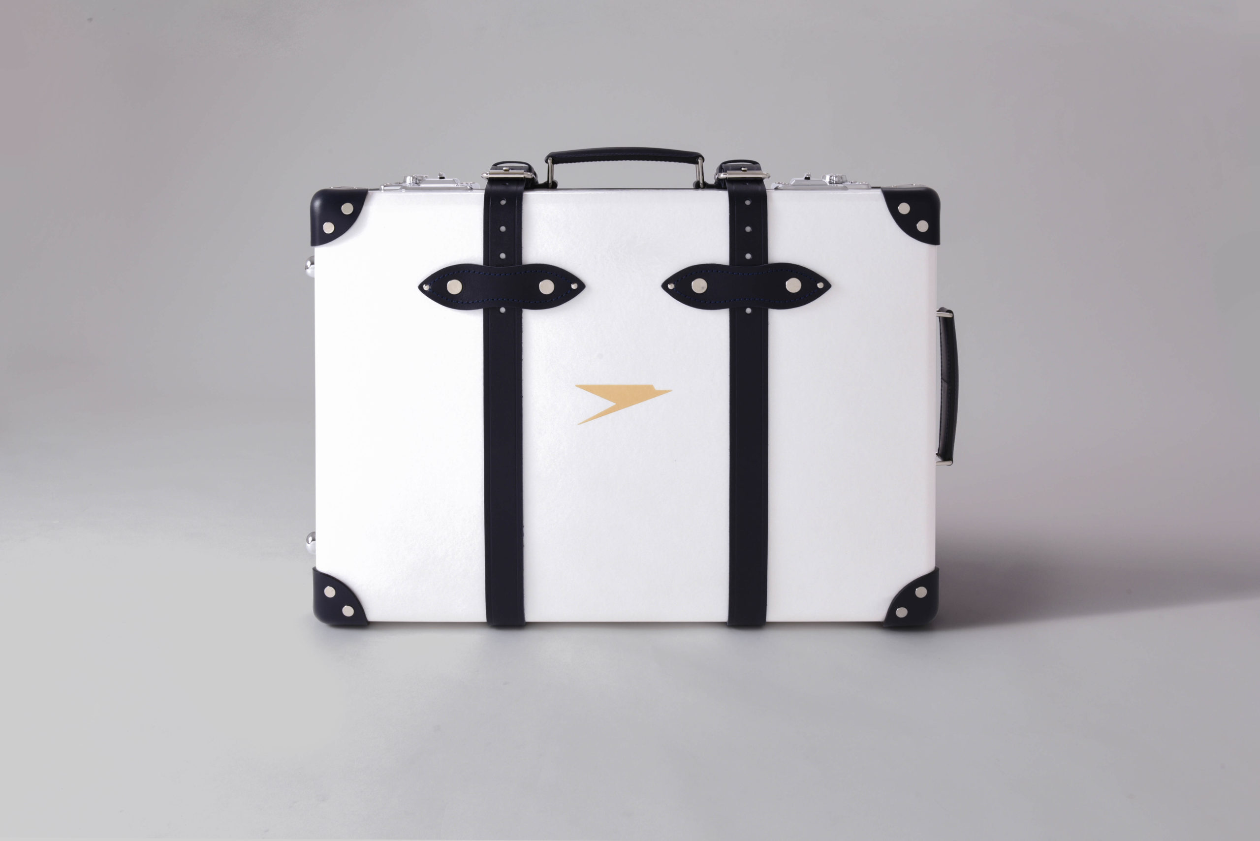 a white suitcase with black straps