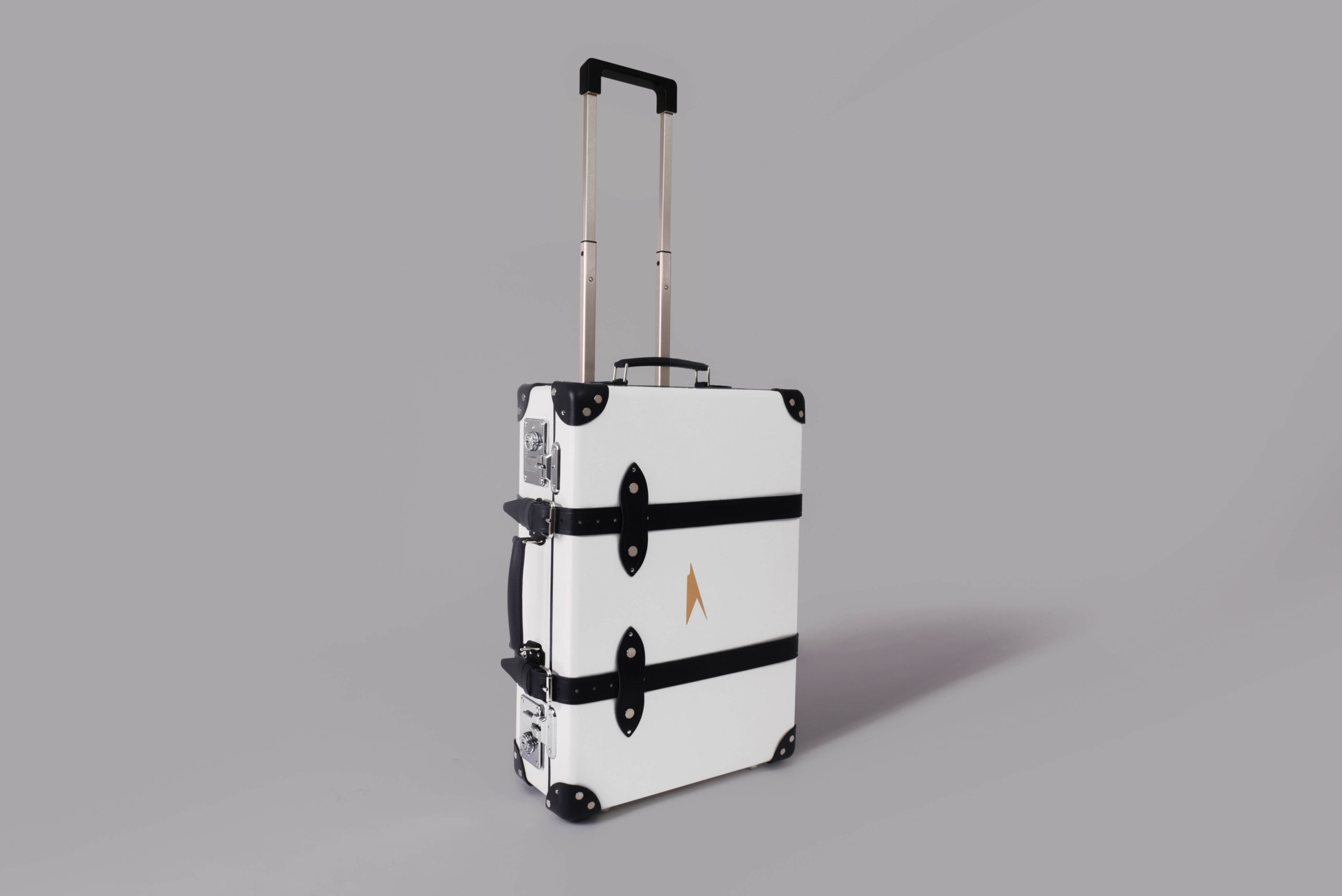 a white suitcase with black straps